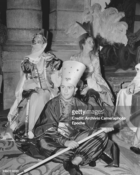 Baroness Afdera Franchetti, Marella Agnelli and Filippo Lacloche at a masked costume ball at the Palazzo Labia, Venice, 3rd September 1951. Named 'Le...