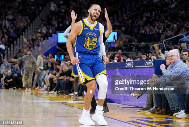 Stephen Curry of the Golden State Warriors reacts towards the Toronto Raptors bench after he made a three-point shot during the third quarter at...