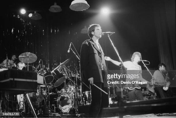 Singers Tom Robinson and Peter Gabriel performing at the Hammersmith Odeon in London, during the Rob & Gab Xmas charity show, 24th December 1978....