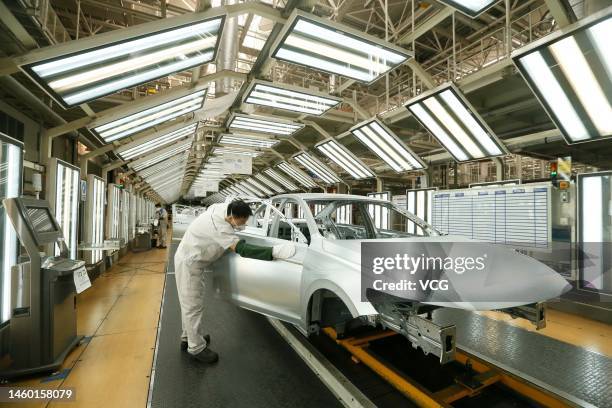 Car bodies are assembled at the Qingdao branch of FAW-Volkswagen Automobile Co., Ltd, a joint venture between FAW Group and Volkswagen Group, on...