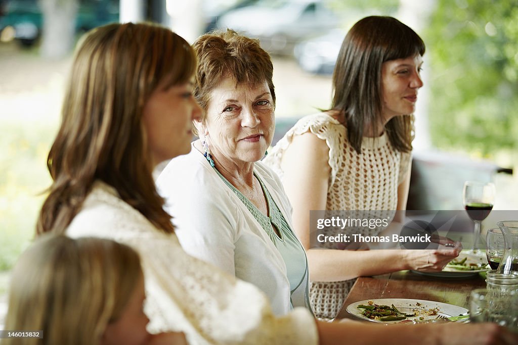 Mother sitting between two daughters at table