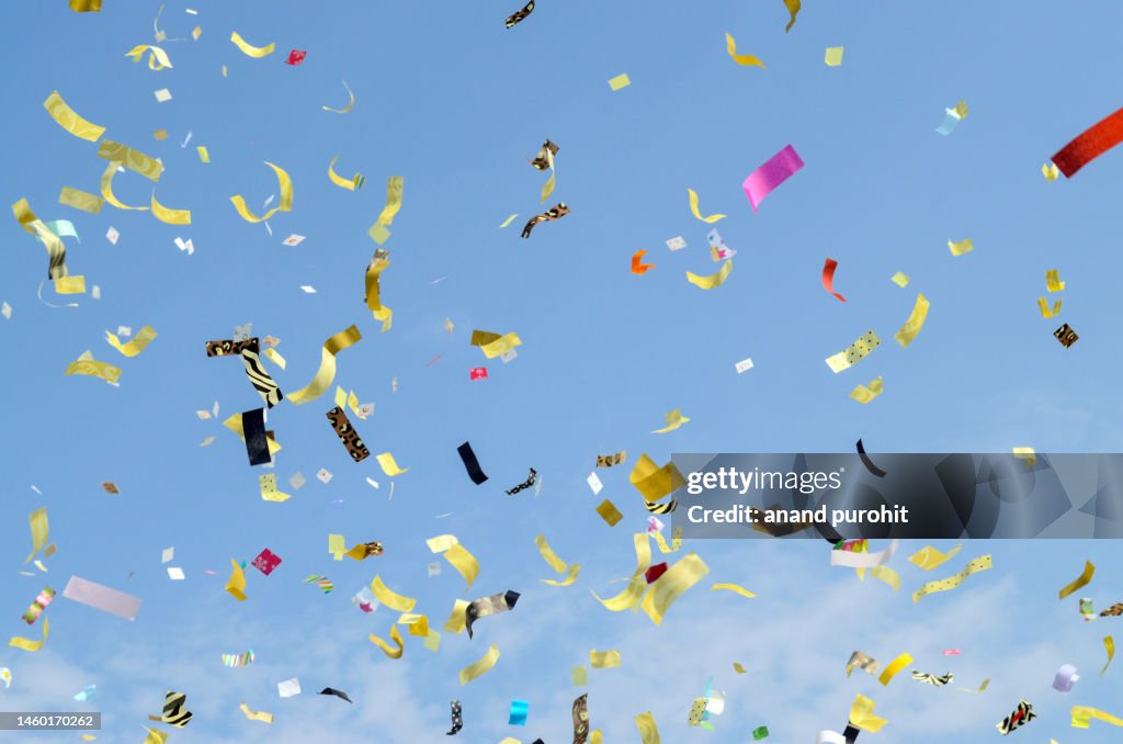 Celebration paper ribbons confetti blast colourful party background