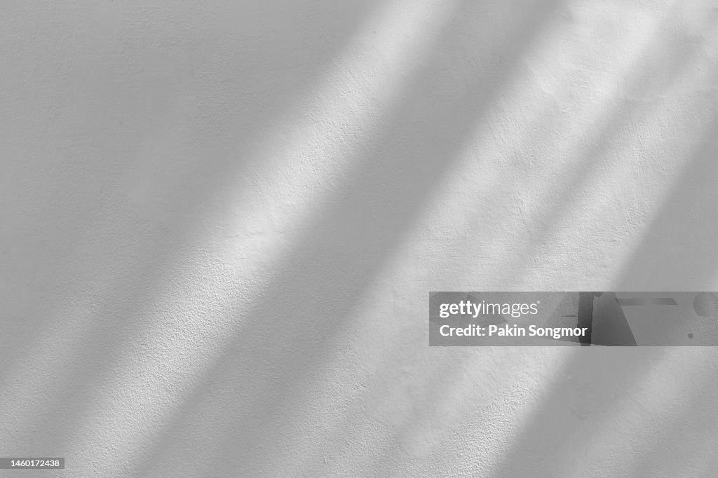 Window shadow drop on white color old grunge wall concrete texture as background.