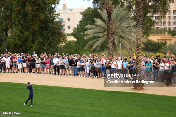 Rory McIlroy of Northern Ireland plays their second shot on the 3rd hole during the continuation of Round Two on Day Three of the Hero Dubai Desert...