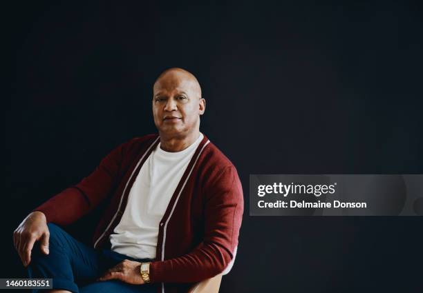 mature man, studio portrait and mockup space on a black background for luxury lifestyle, success and confidence. male model on a chair with copyspace for promotion, product placement and motivation - black male portrait serious stock pictures, royalty-free photos & images