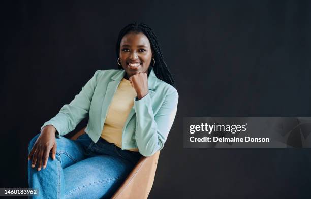 confident, happy and portrait of black woman isolated on dark background sitting in chair for success and hr mockup. human resources, empowerment and smart person smile with studio mock up or space - office chair stockfoto's en -beelden