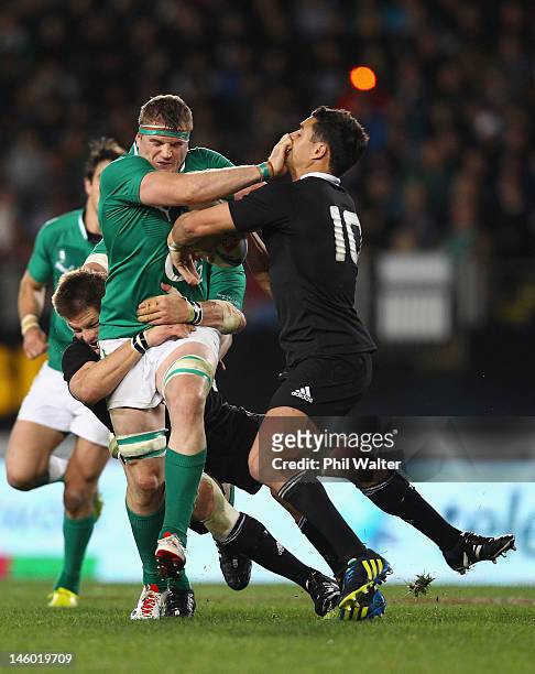 Jamie Heaslip of Ireland fends off Dan Carter of the All Blacks during the International Test Match between the New Zealand All Blacks and Ireland at...