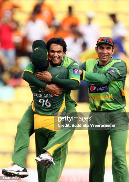 Mohammad Hafeez of Pakistan celebrates with team-mate after taking the wicket of Sri Lankan batsman Kumar Sangakkara during the second one day...