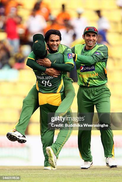 Mohammad Hafeez of Pakistan celebrates with team-mate after taking the wicket of Sri Lankan batsman Kumar Sangakkara during the second one day...