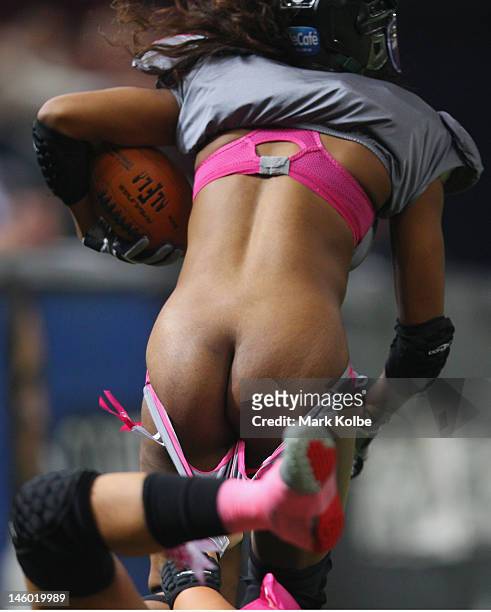 An Eastern Conference "NSW Blues" player has her pants pulled down as she is tackled during game two of the All-Star Lingerie Football League tour at...