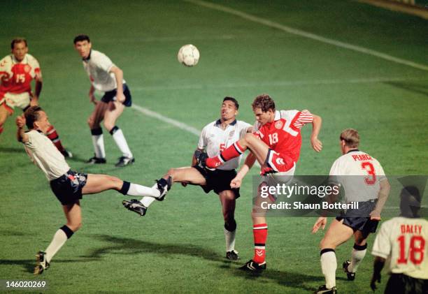 Kim Vilfort of Denmark clears the ball from danger as David Platt and Des Walker of England make a challenge during the UEFA European Championships...