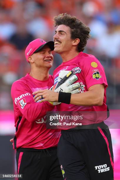 Josh Philippe AND Sean Abbott of the Sixers celebrate the wicket of Josh Inglis of the Scorchers during the Men's Big Bash League match between the...