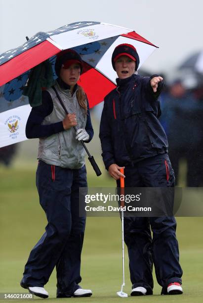 Austin Ernst of the United States with her partner Brooke Pancake on the green at the 16th hole during the morning foursomes matches in the 37th...