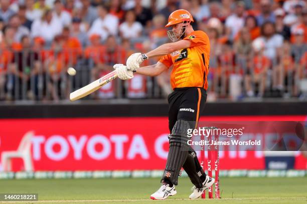 Ashton Turner of the Scorchers lifts the ball for six runs during the Men's Big Bash League match between the Perth Scorchers and the Sydney Sixers...
