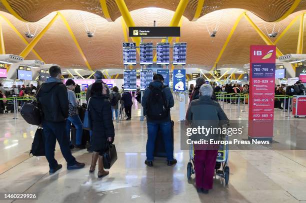 Several people wait to board and check in at the departures area of Terminal 4 at Madrid-Barajas Adolfo Suarez Airport, Jan. 28 in Madrid, Spain. A...