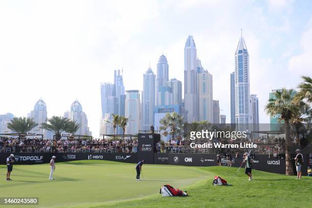 Rory McIlroy of Northern Ireland putts on the 16th green during the continuation of Round Two on Day Three of the Hero Dubai Desert Classic at...