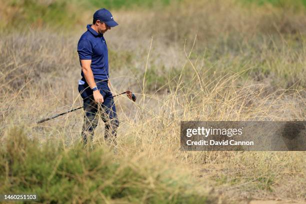 Rory McIlroy of Northern Ireland looks at his ball deep in rough after his tee shot on the 10th hole during the completion of the second round on Day...