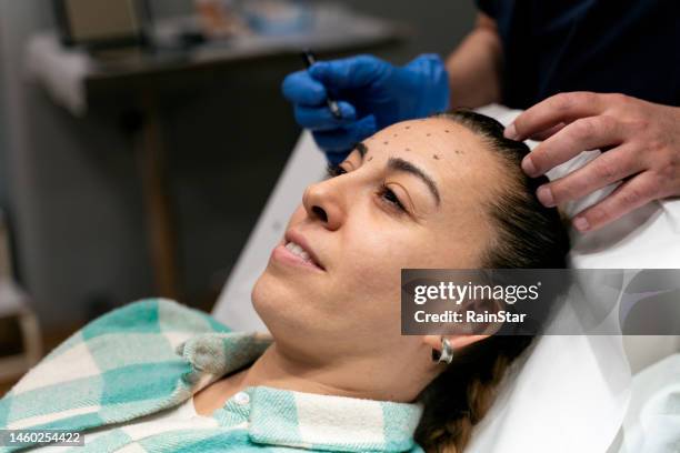 a botox injection for a anti-aging treatment - receiving blood stock pictures, royalty-free photos & images