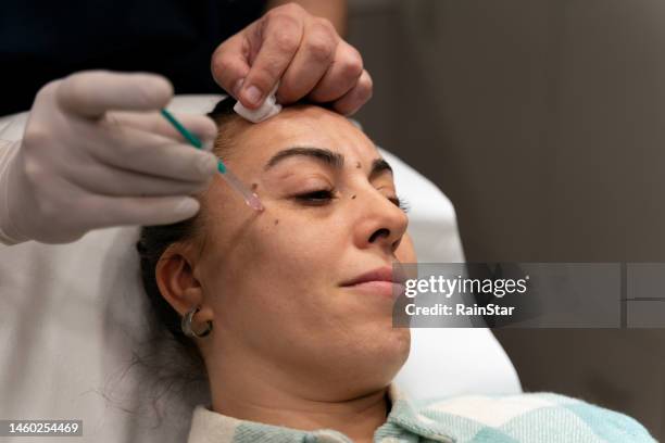 woman receiving botox injection - receiving blood stock pictures, royalty-free photos & images