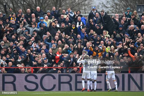 Luis Sinisterra of Leeds United celebrates in front of the fans with teammates Georginio Rutter and Marc Roca after scoring the team's third goal...