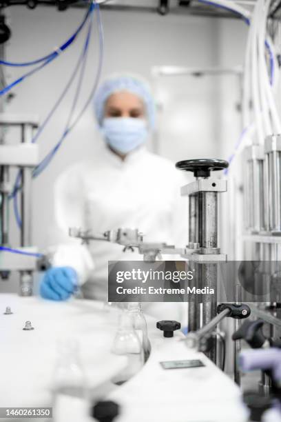 pharmaceutical bottle manufacturing - blowing, filling, capping and labeling - pharmaceutical manufacturing machine stock pictures, royalty-free photos & images