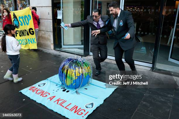 Extinction rebellion activists protest against the funding of the fossil fuel industry outside a branch of Barclays Bank on January 28, 2023 in...