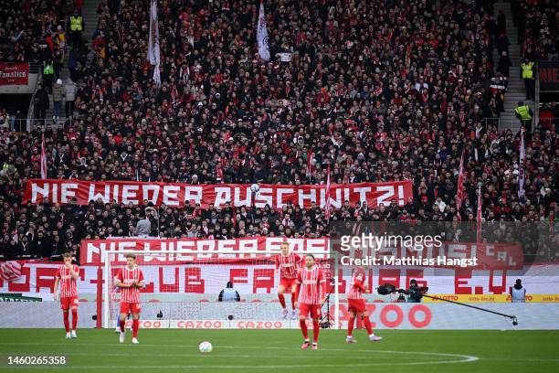 Freiburg fans hold a banner reading 'Never Again Auschwitz' during the Bundesliga match between Sport-Club Freiburg and FC Augsburg at Europa-Park...
