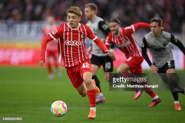 Ritsu Doan of SC Freiburg runs with the ball during the Bundesliga match between Sport-Club Freiburg and FC Augsburg at Europa-Park Stadion on...