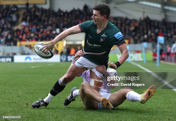 Freddie Burns of Leicester Tigers off loads the ball as Ollie Sleightholme holds on during the Gallagher Premiership Rugby match between Leicester...