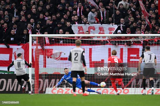 Mark Flekken of SC Freiburg fails to save a shot from Mergim Berisha of FC Augsburg, who scores the team's first goal from the penalty spot during...