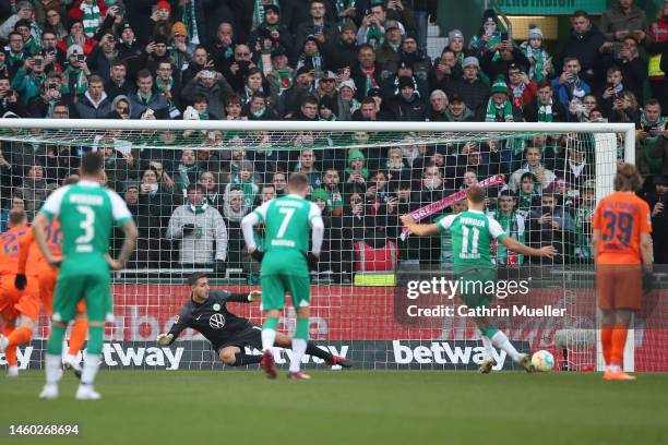 Niclas Fuellkrug of SV Werder Bremen scores the team's first goal as Koen Casteels of VfL Wolfsburg attempts to make a save during the Bundesliga...