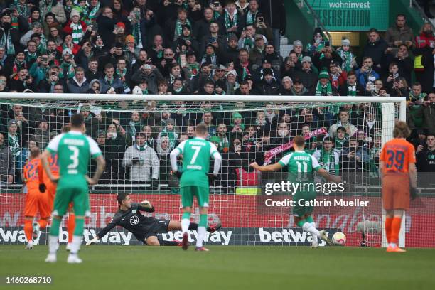 Niclas Fuellkrug of SV Werder Bremen scores the team's first goal as Koen Casteels of VfL Wolfsburg attempts to make a save during the Bundesliga...