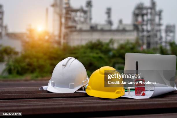 helmet with radio communication and equipment used for industrial dutyand industrial plant background - bauingenieur stock-fotos und bilder