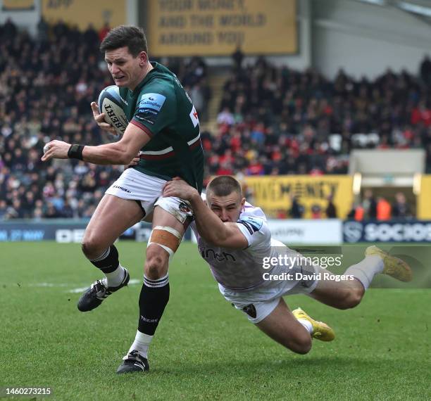 Freddie Burns of Leicester Tigers is held by Ollie Sleightholme during the Gallagher Premiership Rugby match between Leicester Tigers and Northampton...