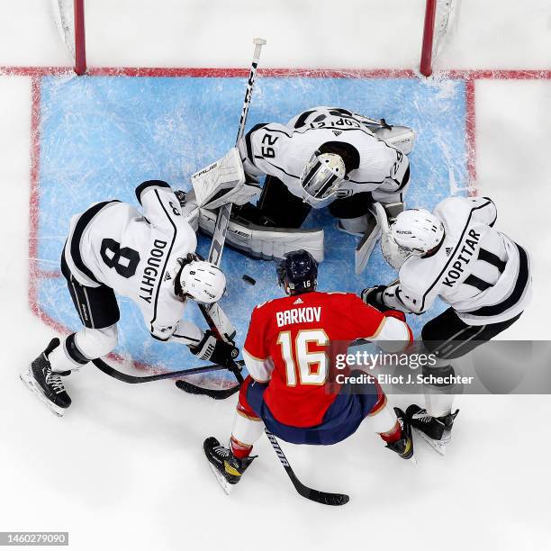 Goaltender Pheonix Copley of the Los Angeles Kings defends the net with the help of teammates Drew Doughty and Anze Kopitar against Aleksander Barkov...