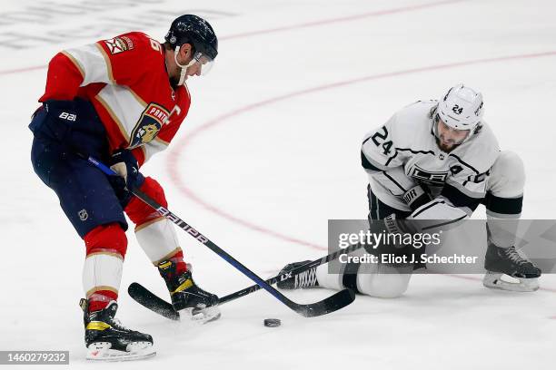 Aleksander Barkov of the Florida Panthers crosses sticks with Phillip Danault of the Los Angeles Kings at the FLA Live Arena on January 27, 2023 in...