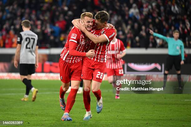 Philipp Lienhart celebrates with Matthias Ginter of SC Freiburg after scoring the team's third goal during the Bundesliga match between Sport-Club...