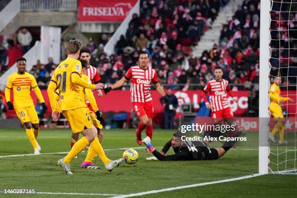 Pedri of FC Barcelona scores the team's first goal as Paulo Gazzaniga of Girona FC looks on during the LaLiga Santander match between Girona FC and...