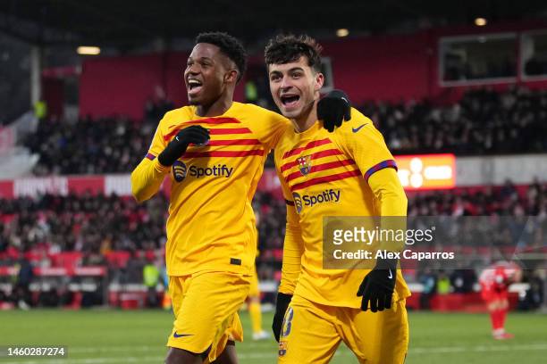 Pedri of FC Barcelona celebrates after scoring the team's first goal with teammate Ansu Fati during the LaLiga Santander match between Girona FC and...
