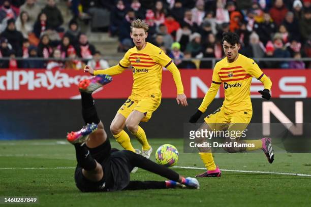 Pedri of FC Barcelona scores the team's first goal as Paulo Gazzaniga of Girona FC looks on during the LaLiga Santander match between Girona FC and...