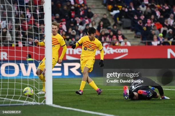 Pedri of FC Barcelona scores the team's first goal as Paulo Gazzaniga of Girona FC looks on during the LaLiga Santander match between Girona FC and...