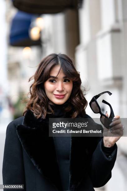 Heart Evangelista wears YSL Saint-Laurent sunglasses, during a street style fashion photo session, on January 28, 2023 in Paris, France.