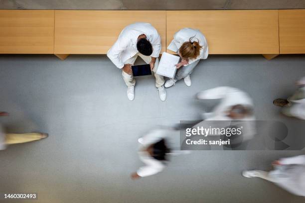 scientists walking in corridor - clinical trials stock pictures, royalty-free photos & images
