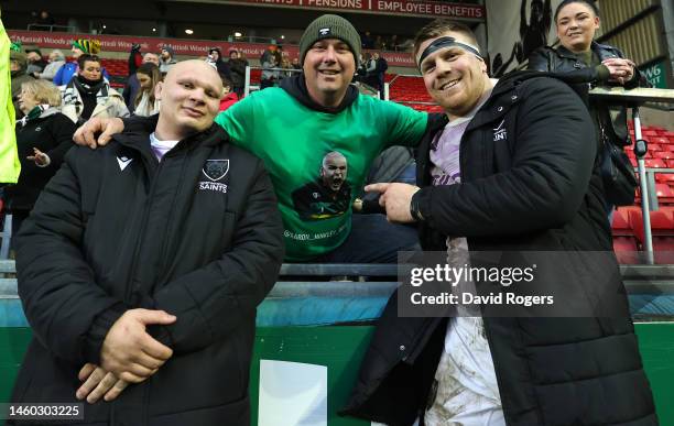 Aaron Hinkley and Paul Hill of Northampton Saints celebrate with a fan after their victory during the Gallagher Premiership Rugby match between...