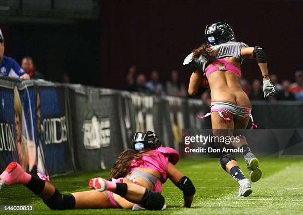 An Eastern Conference player has her pants pulled down as she is tackled during during games two of the All-Star Lingerie Football League tour at...