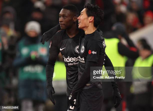 Randal Kolo Muani of Eintracht Frankfurt celebrates with teammate Daichi Kamada after scoring the team's first goal during the Bundesliga match...