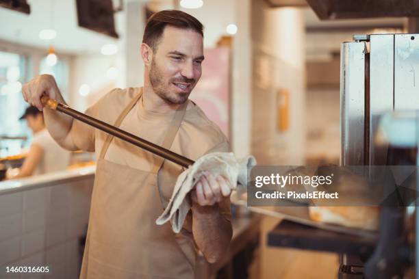 baker baking fresh bread - restaurant owner stock pictures, royalty-free photos & images