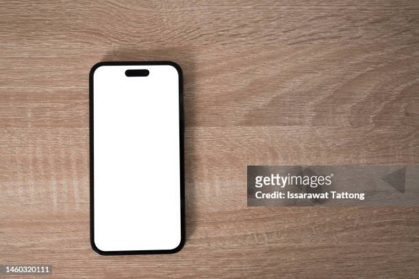 smartphone on wooden table on light background - notepad table stockfoto's en -beelden