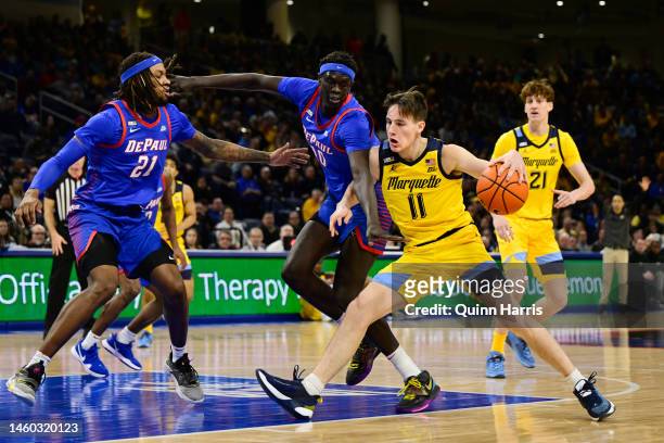 Tyler Kolek of the Marquette Golden Eagles drives with the basketball in the first half against Yor Anei of the DePaul Blue Demons at Wintrust Arena...