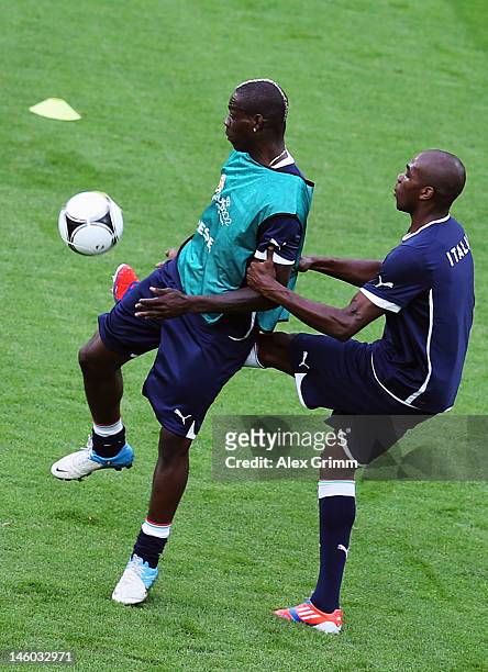Mario Balotelli of Italy is challenged by Angelo Ogbonna during a UEFA EURO 2012 training session ahead of their Group C match against Spain at the...